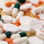 Close-up of various pills and capsules in different colors and sizes, ideal for healthcare-related content.