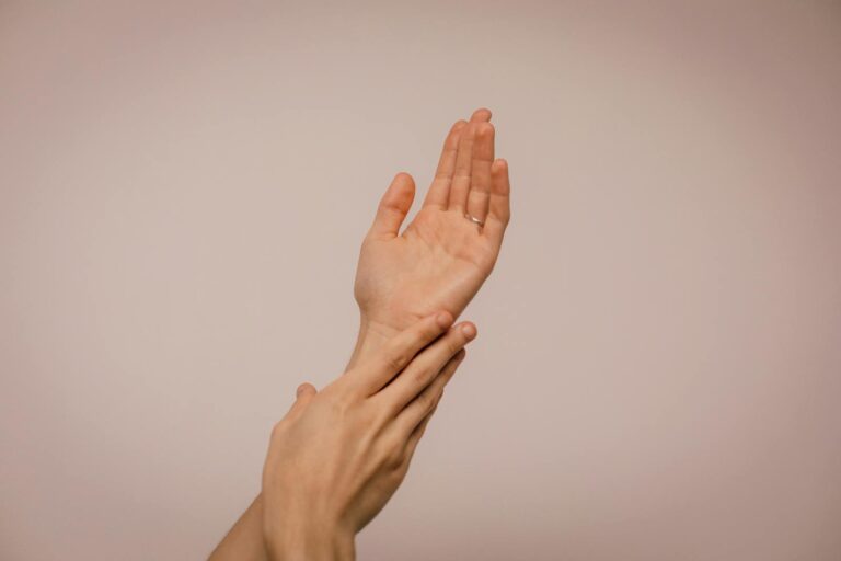 Frambösie (Yaws) Close-up of hands gently caressing each other, symbolizing self-care and softness.