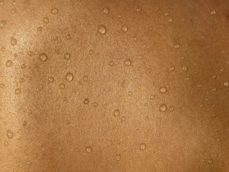 A man's back with water drops on it