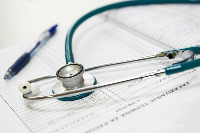 Molybdänmangel A stethoscope and pen resting on a medical report in a healthcare setting.